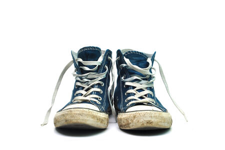 old sneakers dirty sport shoes over white backgroundの写真素材