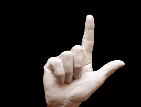 Sign Language American alphabet with hands painted white over black background letter lの写真素材