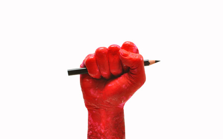 man hand raised fist with pencil freedom of speech symbolの写真素材
