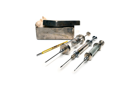 vintage medical syringe set over white backgroundの写真素材