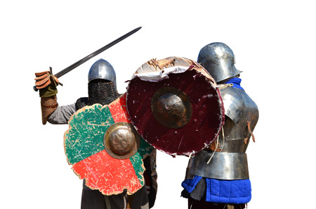 medieval metal armor and helmet mercenary warriors fighting isolated over whiteの写真素材