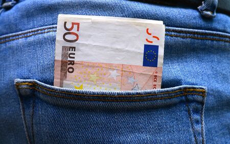 Back pocket with money blue jeans close detail
