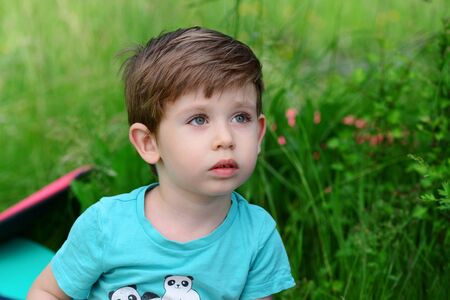 Beautiful blue eyes little kid outdoors backgroundの写真素材