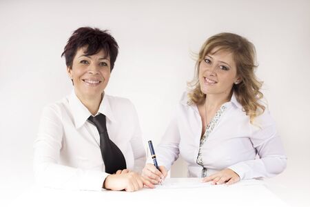 partner signed a check to another partnerの写真素材