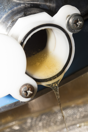 raw honey go down from a steel containerの写真素材