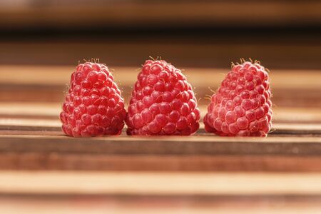 raw raspberries on wooden background