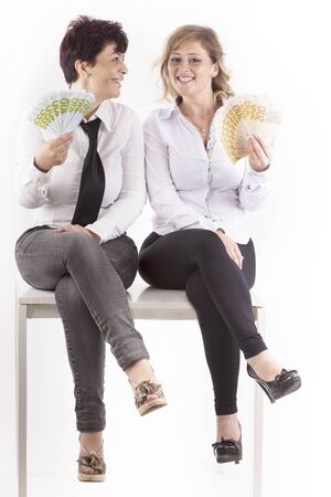 partners shows banknotes earned in the officeの写真素材