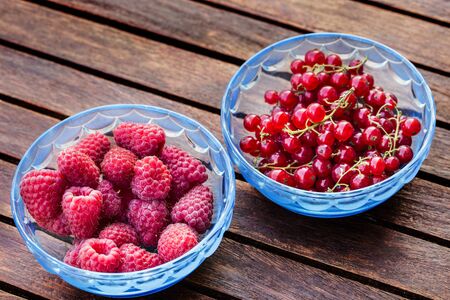 raw raspberries and currant in the glassの写真素材