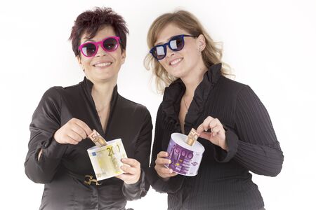 partners put banknotes in the piggy bankの写真素材