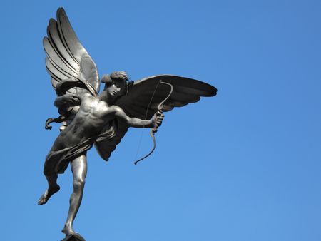 The aluminium statue of Eros the greek mythological  God Of Love, stands at the top of The Shaftesbury Memorial Fountain in London's Piccadilly Circusの写真素材