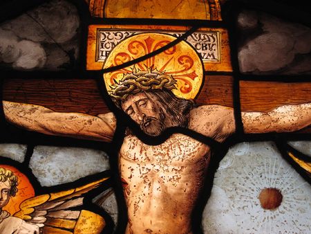 The crucifixion of Christ shown in an image on a medieval 16th century stained glass panelの写真素材