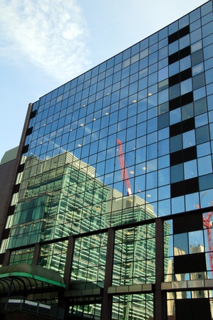 Reflection of a construction site office block skyscraper, in glass windows, at Birmingham, Englandの写真素材