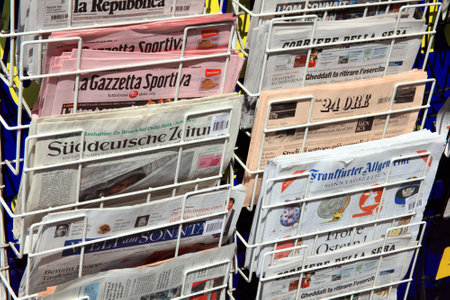 London, United Kingdom, Apr 24, 2011 : International newspapers displayed outside a newsagent's shop in Kensington for sale to touristsのeditorial素材
