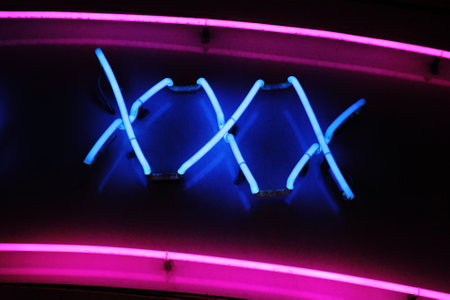 XXX neon sign advertising an adult licensed sex shop in a red light district