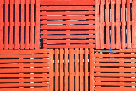 Abstract background of old wooden pallets made into an orange fenceの写真素材