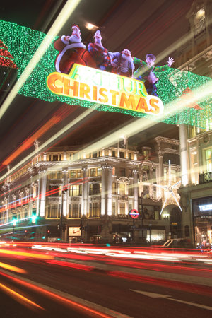 London, UK - November 12, 2011: Christmas lights at Oxford Circus at night, showing some of the displays from Regent Street and Oxford Street during the festive season, with blurred light trails from passing vehicles.のeditorial素材