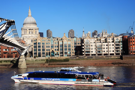London, UK - January 14, 2012:  The Thames Clipper having just passed through the Millennium Bridgのeditorial素材