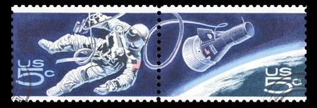 USA vintage 1967 postage stamps commemorating Gemini 4 over Earth showing an astronaut making a space walkの写真素材