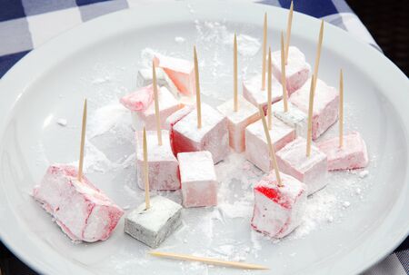 Turkish delight sweets displayed on a white plate