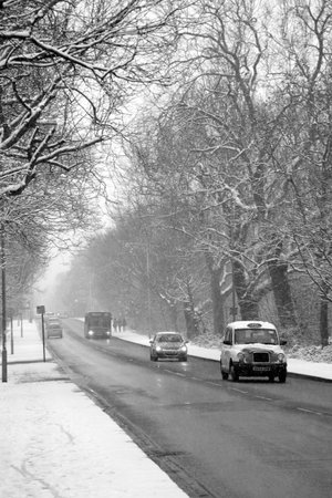 London, UK ? Jan 20, 2013 : Black & White image of heavy snowfall on a South London during rush hour trafficのeditorial素材