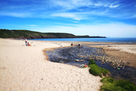 Pembrokeshire, Wales, UK, May 21, 2014 : Holidaymakers on vacation making the most of the summer sun on the golden sandy beach of Freshwater coastlineのeditorial素材