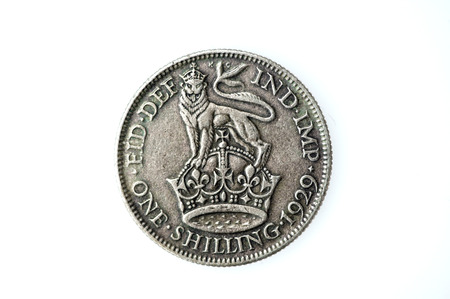 George V silver English shilling, which is now an obsolete coin of England, UK. It's value was twelve pence, one twentieth of the pound at that timeの写真素材