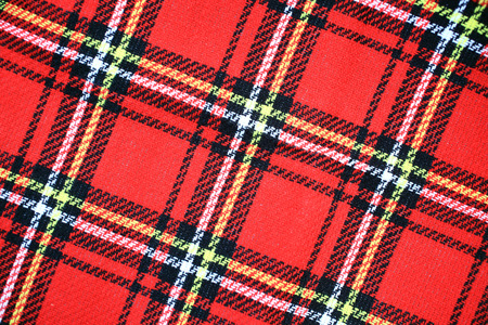 Red Scottish tartan plaid material pattern backgroundの写真素材