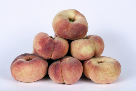 Flat peaches isolated on a white backgroundの写真素材