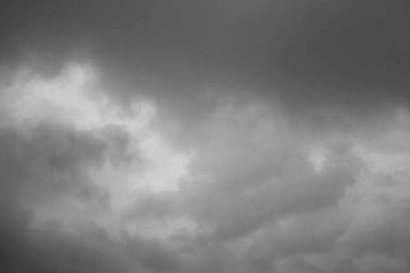 Cloudscape background of overcast cumulus clouds black & white monochrome image