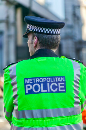 London, England, UK, January 1, 2010 : Back view of a metropolitan police officer on duty in the City of London England UK stock photo imageのeditorial素材