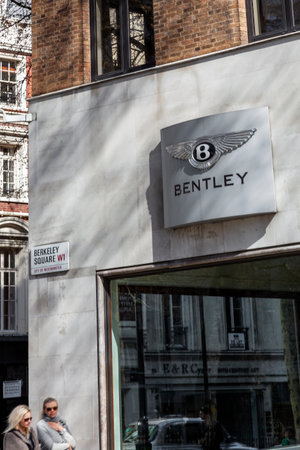 London, UK, April 1, 2012 : Bentley sign advertising logo at their car showroom dealership a business selling luxury cars and SUVs and a stock photo imageのeditorial素材