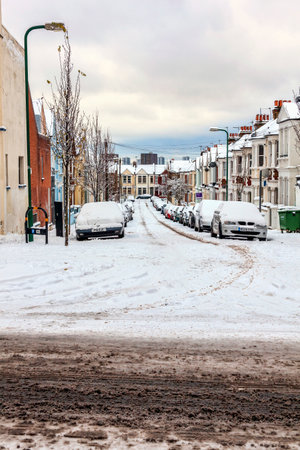 London, UK, December 18, 2010 : street winter cityscape with snow terraced houses and frozen cars after a blizzard snowfall, stock photo imageのeditorial素材