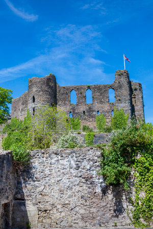 Laugharne Castle in Carmarthenshire south Wales UK which is an 12th century Norman fort ruin with and is a popular tourist travel destination landmark, stock photo imageのeditorial素材