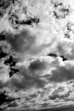 Cloudscape background texture of  white fluffy cumulus clouds, Black and white monochrome stock photo imageの写真素材