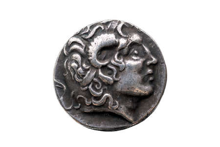 Greek silver Drachum coin replica of  Alexander the Great dated from 336-323 BC cut out and isolated on a white background, stock photo imageの写真素材