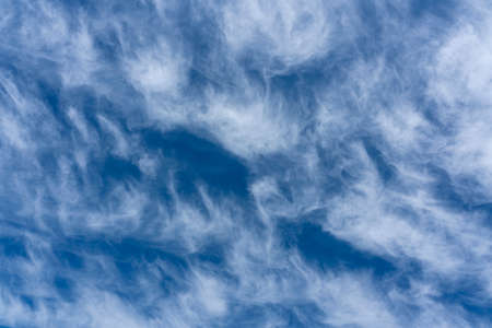White clouds on a blue sky for use as a cloudscape texture background, stock photo imageの写真素材