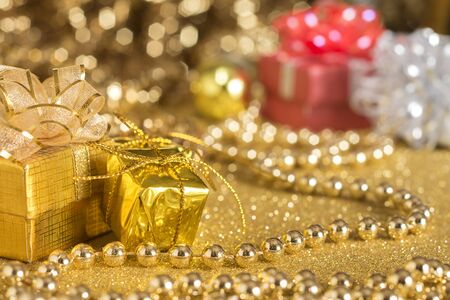 Golden Gift, Christmas gift on golden backgroundの写真素材