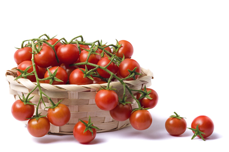 Basket of cherry tomato, isolated on white backgroundの写真素材