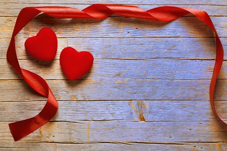 Red hearts and red ribbon on old wooden table, Valentine's Dayの写真素材