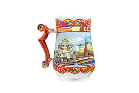 ceramic souvenir toy in the form of mug with beautiful color painting on isolated white background reflecting the national Russian culture with the inscription in Russian: city name Moscowの写真素材