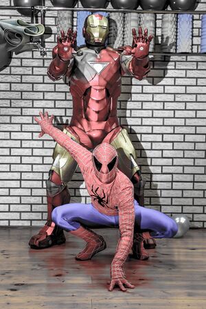 RUSSIA, YAROSLAVL - 17 NOV. 2018: Animators iron man and spider man in the fitness room at a corporate party. Toned.のeditorial素材