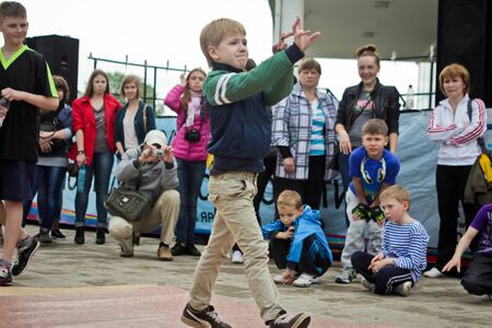 RUSSIA, YAROSLAVL - 25 MAY. 2013: breakdance battle competition in a street outdoor among group of teams kids, teenagers and adults hip-hop bboys. Dancing in fountains, portrait.のeditorial素材