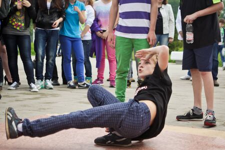 RUSSIA, YAROSLAVL - 25 MAY. 2013: breakdance battle competition in a street outdoor among group of teams kids, teenagers and adults hip-hop bboys. Dancing in fountains, portrait.のeditorial素材