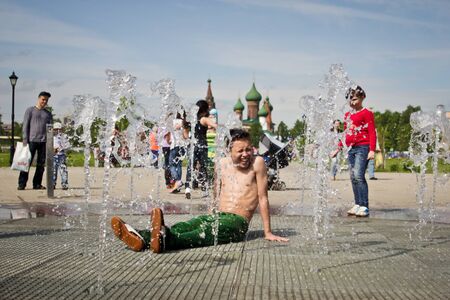 RUSSIA, YAROSLAVL - 25 MAY. 2013: breakdance battle competition in a street outdoor among group of teams kids, teenagers and adults hip-hop bboys. Dancing in fountains, portrait.のeditorial素材