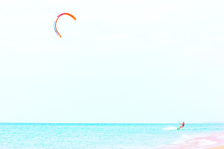 brave man kite sailing on the black sea with a sail wing in his hands led by the wind on a bright sunny day.のeditorial素材