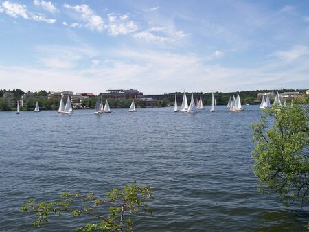 a summertime scene from stockholm of various types of sailing vessels on the riverの写真素材