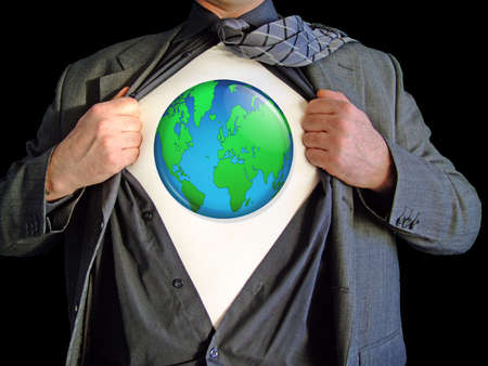 A business man isolated against a black background tearing open his shirt to reveal a  world map on a t shirtの写真素材