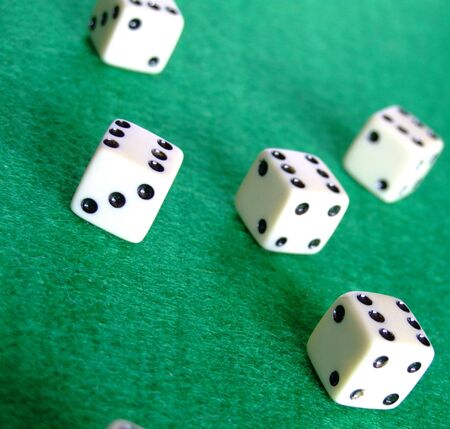 A selection of gambling dice on a green felt surface