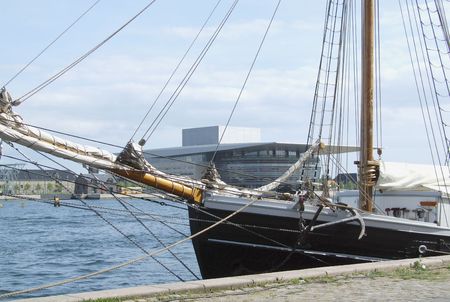 View of the modern opera house building and old tallship situated in the danish capital city of Copenhagenの写真素材