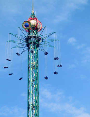 fairground ride in copenhagens tivoli set against a blue summer skyの写真素材